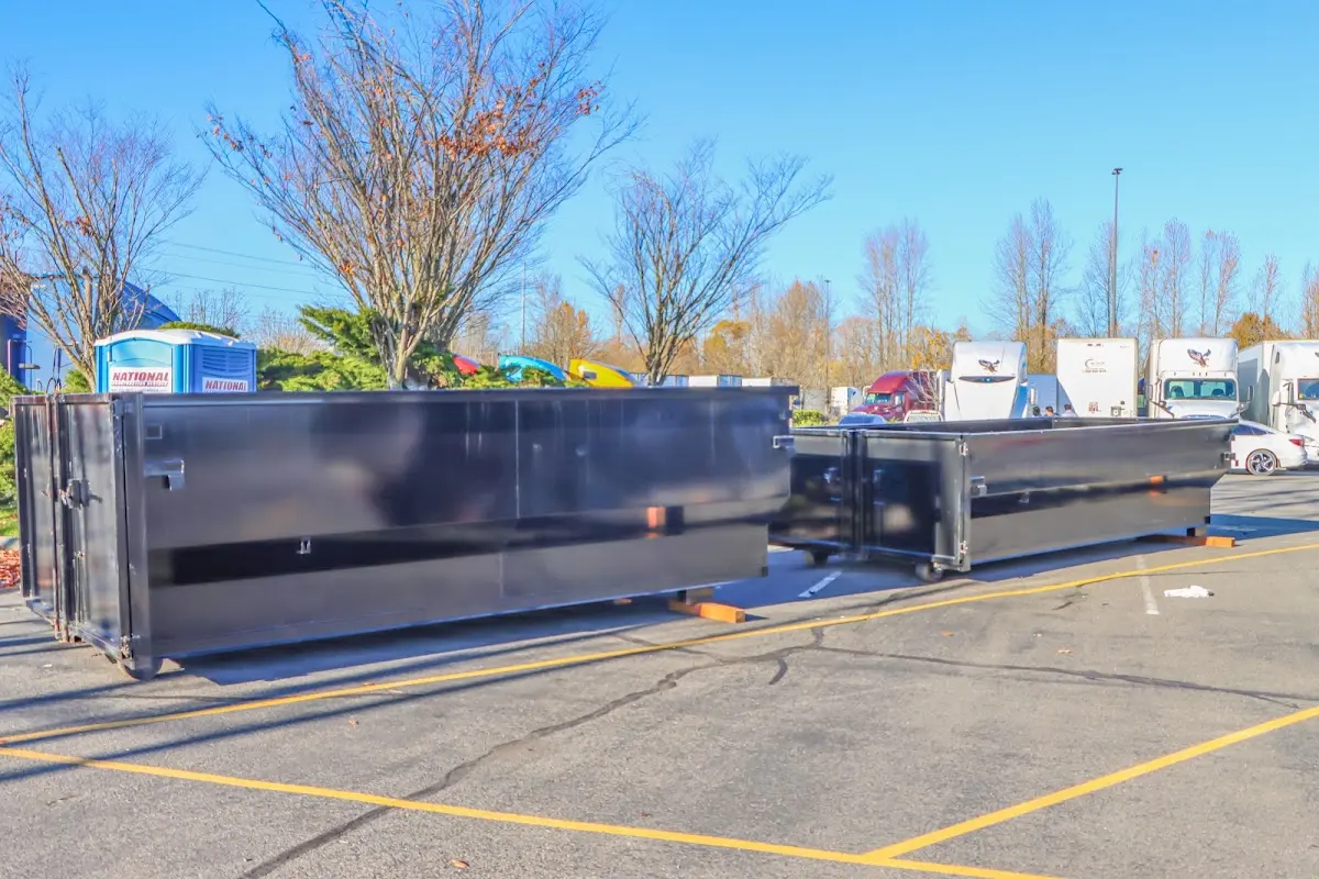 Professional dumpster rental service with roll-off container on residential driveway in Bethesda